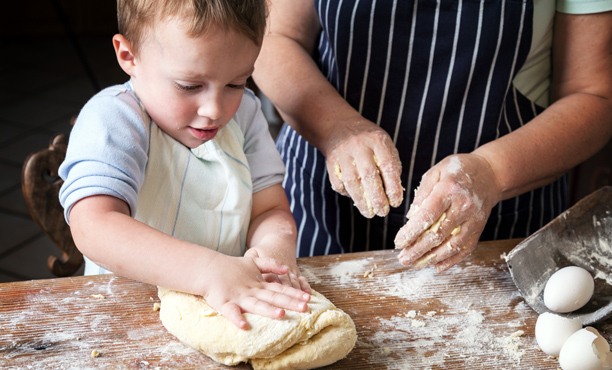 A child rolling dough