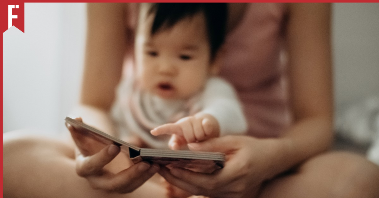 a woman reading to her baby