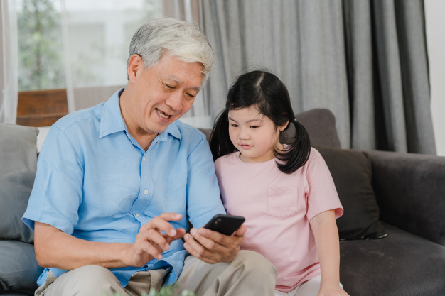 asian-grandparents-granddaughter-using-mobile-phone-home-senior-chinese-grandpa-kid-happy-spend-family-time-relax-with-young-girl-checking-social-media-lying-sofa-living-room 7861-1920