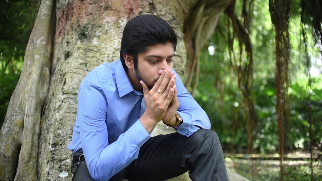 videoblocks-a-depressed-and-heart-broken-lonely-asian-indian-man-is-feeling-hopeless-and-sitting-under-a-tree-in-a-forest-or-park sixz0z62l7 thumbnail-full01