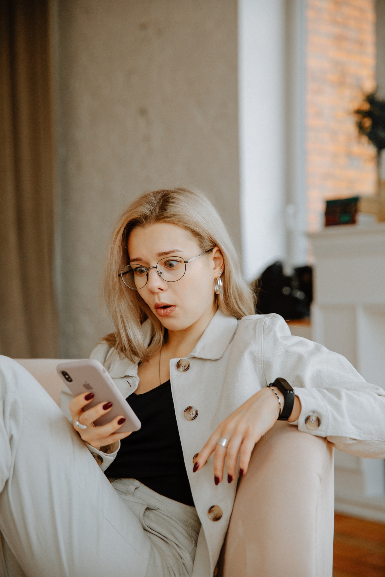 woman-in-beige-coat-holding-smartphone-3958892