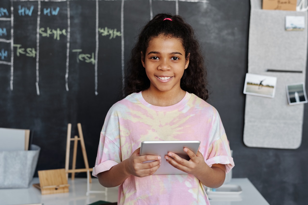 woman-in-pink-crew-neck-t-shirt-holding-tablet-computer-4144038