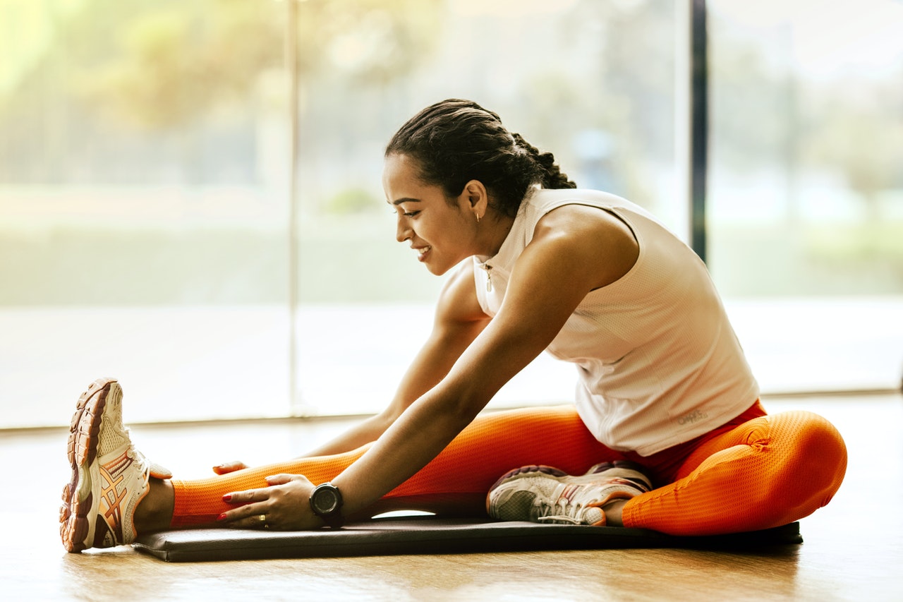 woman-stretching-on-ground-3076509