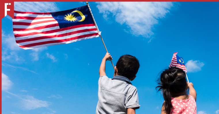 Kids waving the Jalur Gemilang in the air