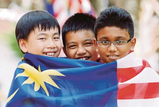 multiracial kids wrapped in Jalur Gemilang