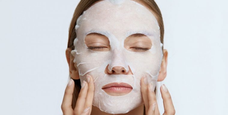 woman staying cool by wearing a white face mask