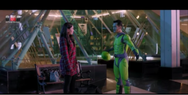 Badrol showing off his green costume to Tisya