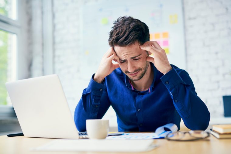 Man crying in front of his computer