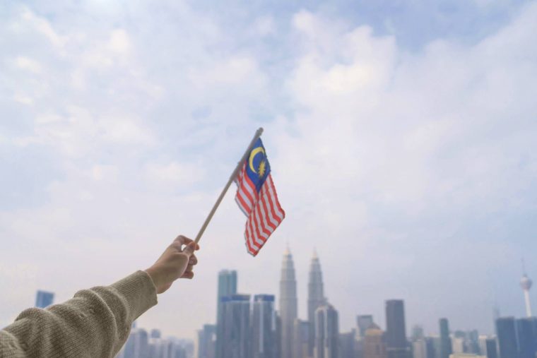 A Malaysian flag being waved in front of KLCC