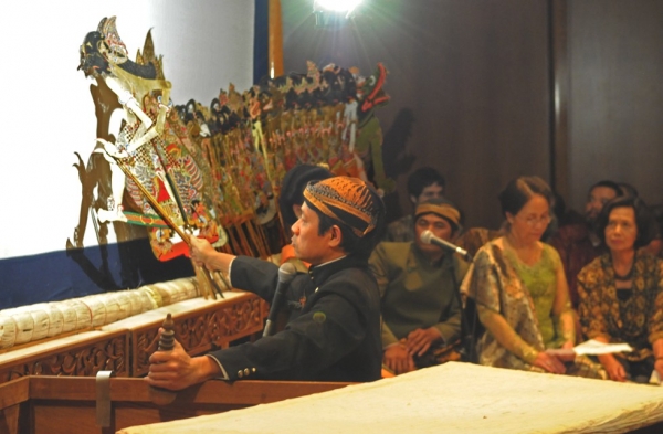 A puppeteer doing wayang kulit