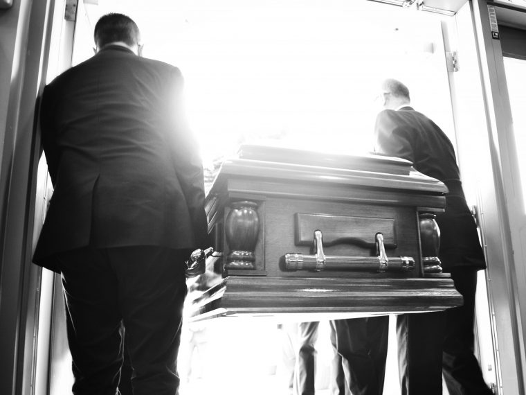 two men carrying a casket