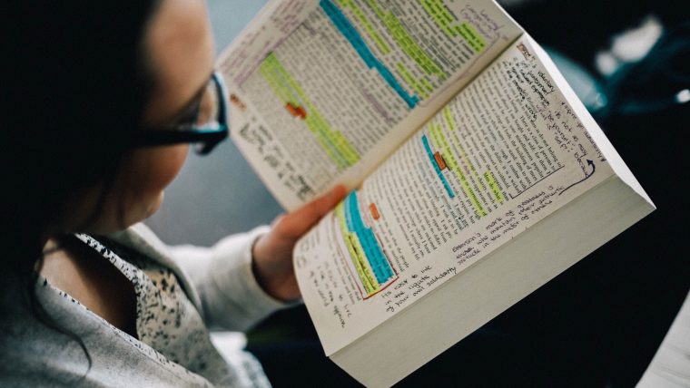 a woman annotating a book