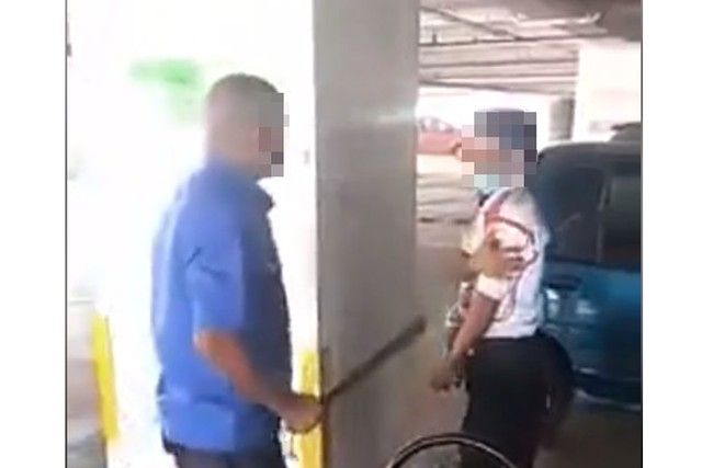 a man attacking a security guard with a stick