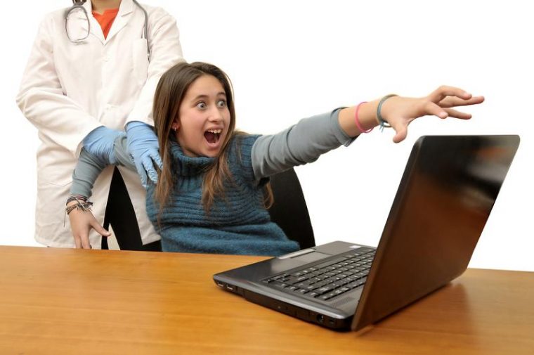 anti-vaxxer woman being dragged away from her computer