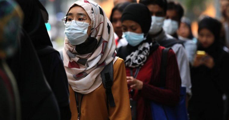 Malaysians wearing facemasks while going outside