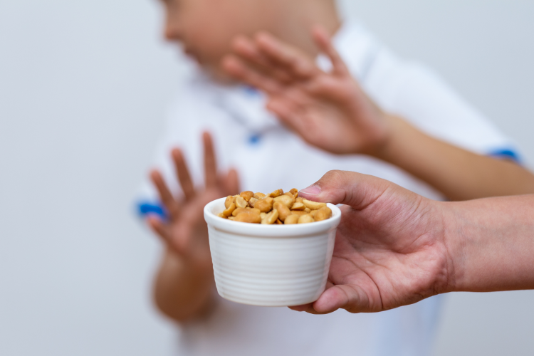 man recoiling from a bowl of nuts