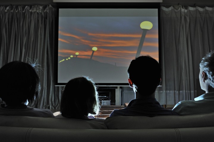 family enjoying movie night together