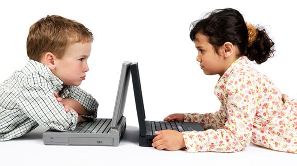 two children arguing over their laptops