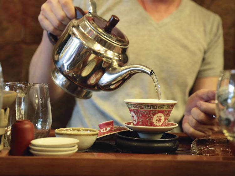 man pouring hot water to make tea