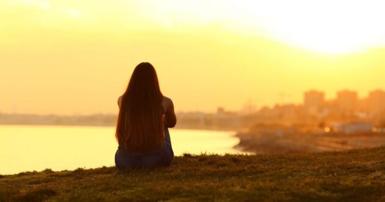 woman taking a break and looking at the sunset