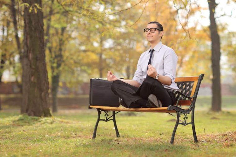 a person meditating in the park