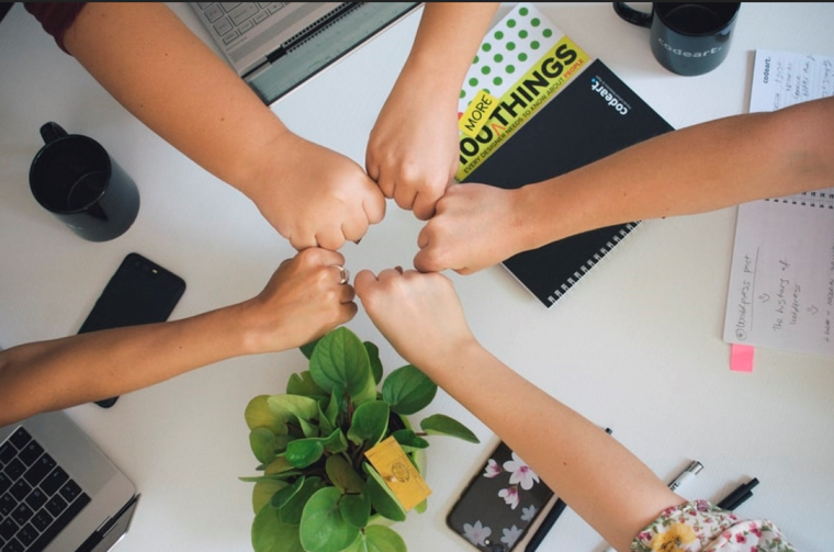 a group doing fist bumps