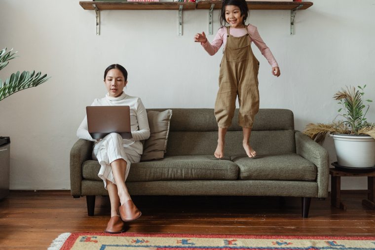 mother working from home with child next to her