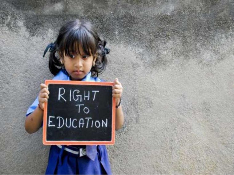 a girl holding a sign that says "Right To Education"